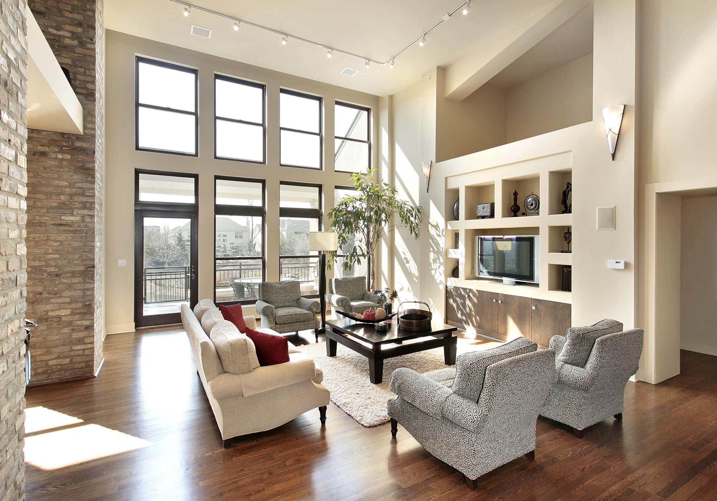 Family room in open floor plan with windows to balcony